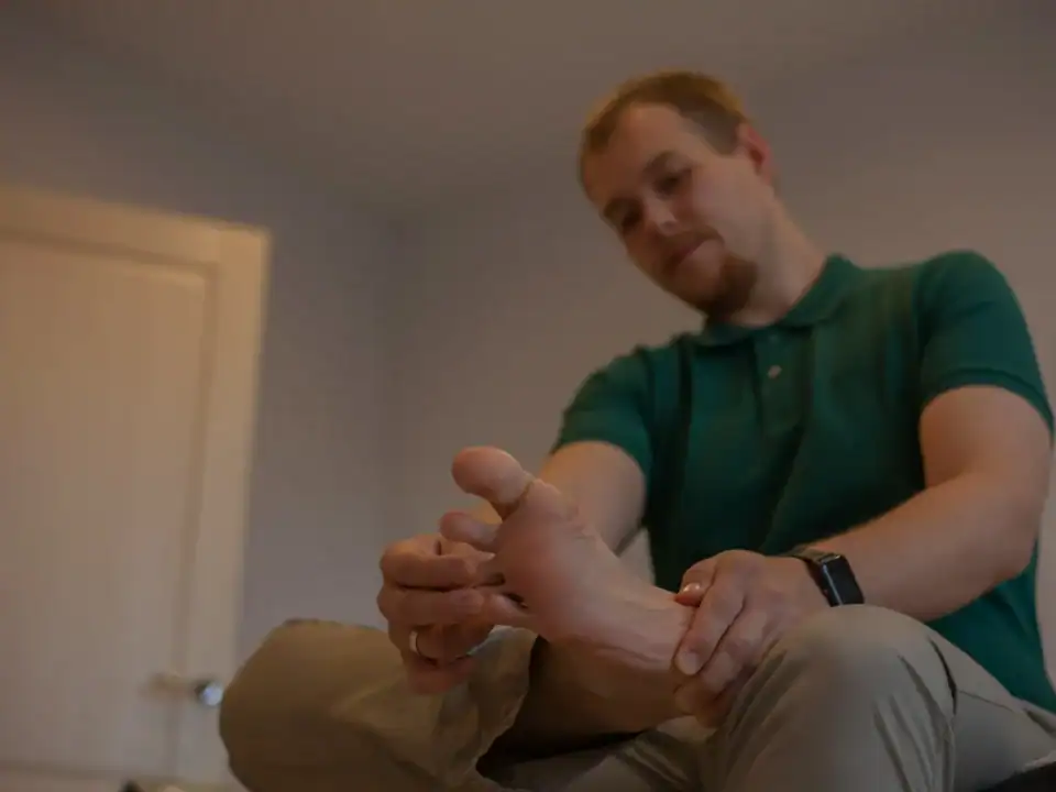Healthcare provider examining a patient's foot during a diabetic neuropathy assessment